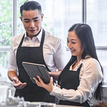 Business team reviews payment options on a tablet.